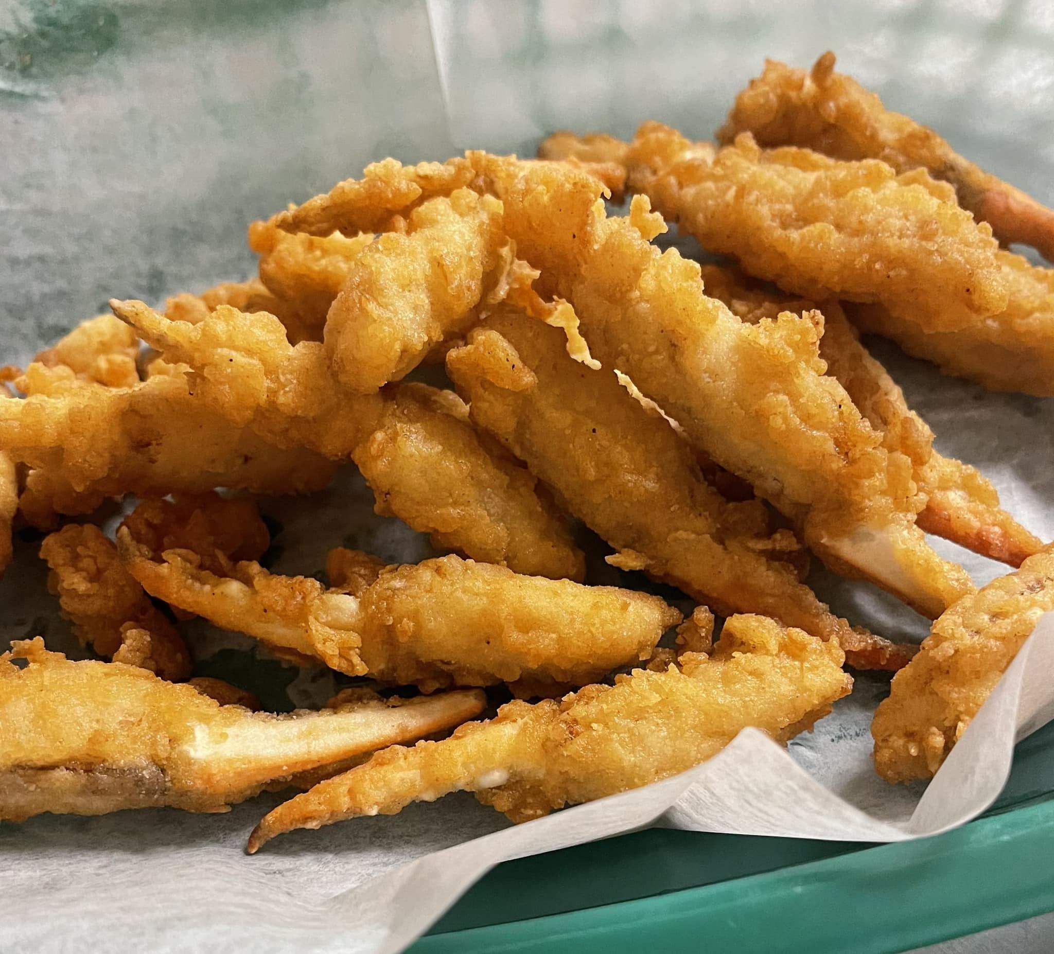 Golden fried crab claws with dipping sauce